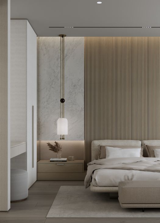 Modern bedroom at Williams Island Residence featuring a neutral palette with upholstered bed, marble and wood accent wall, built-in nightstand with pendant light, and minimalist decor. Design by Troy Dean Home.